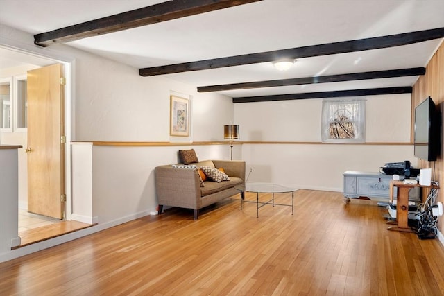 sitting room with beam ceiling and light hardwood / wood-style flooring