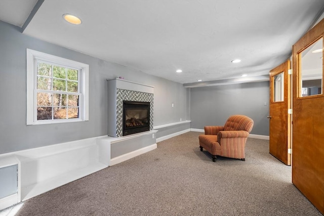 living area featuring carpet flooring and a fireplace