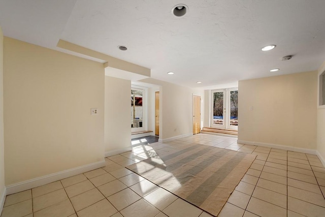 tiled spare room with french doors