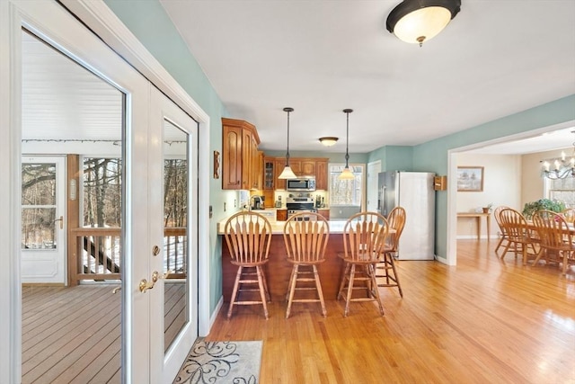 dining area with a notable chandelier and light hardwood / wood-style flooring