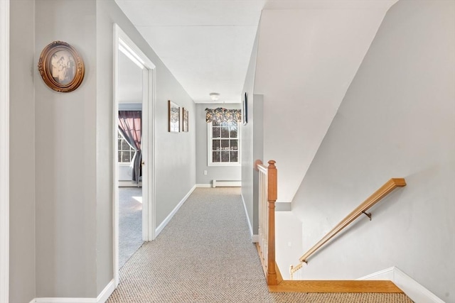 corridor with light colored carpet and a baseboard radiator