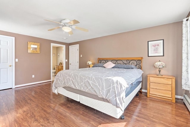 bedroom with ceiling fan, baseboard heating, hardwood / wood-style floors, and ensuite bath