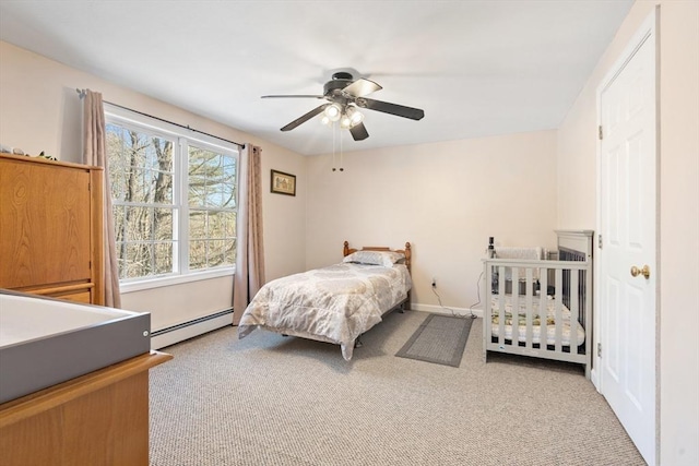 carpeted bedroom featuring ceiling fan and baseboard heating