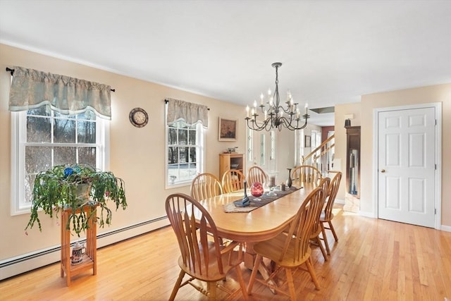 dining room featuring a chandelier and light hardwood / wood-style flooring