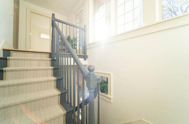 staircase featuring a high ceiling