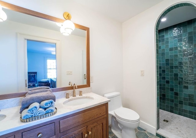 ensuite bathroom featuring toilet, connected bathroom, vanity, tiled shower, and tile patterned floors