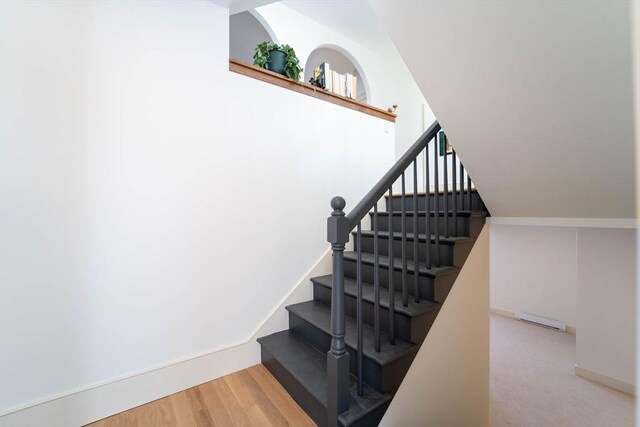 stairs featuring baseboards and wood finished floors