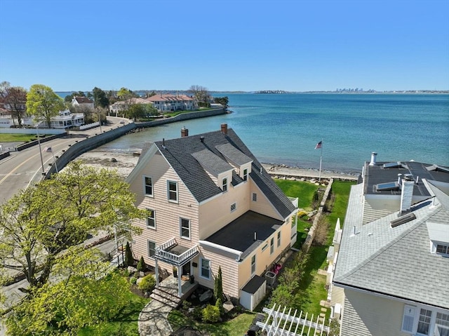 aerial view of property and surrounding area with a nearby body of water