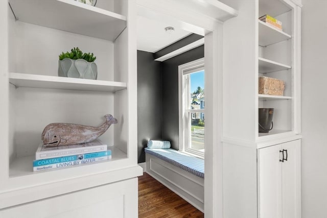 detailed view of wood finished floors and a smoke detector