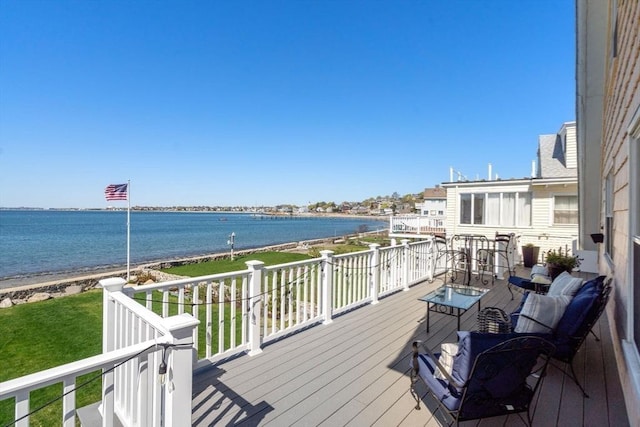 wooden terrace featuring a water view