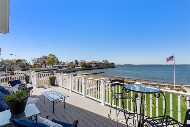 deck with view of water and beach