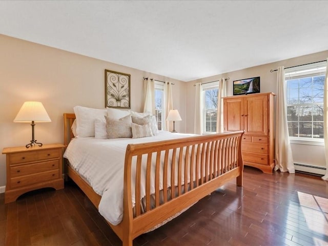 bedroom featuring baseboard heating and wood-type flooring