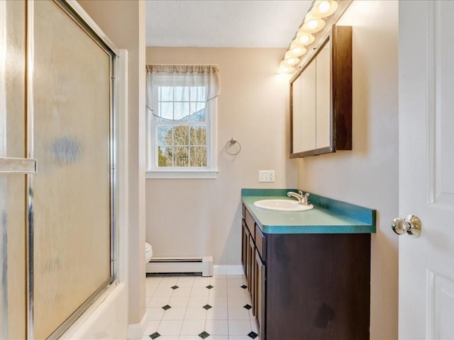 bathroom with baseboards, toilet, baseboard heating, a shower with shower door, and vanity