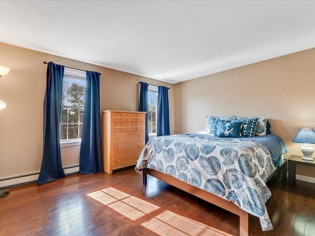 bedroom featuring a baseboard radiator and hardwood / wood-style floors