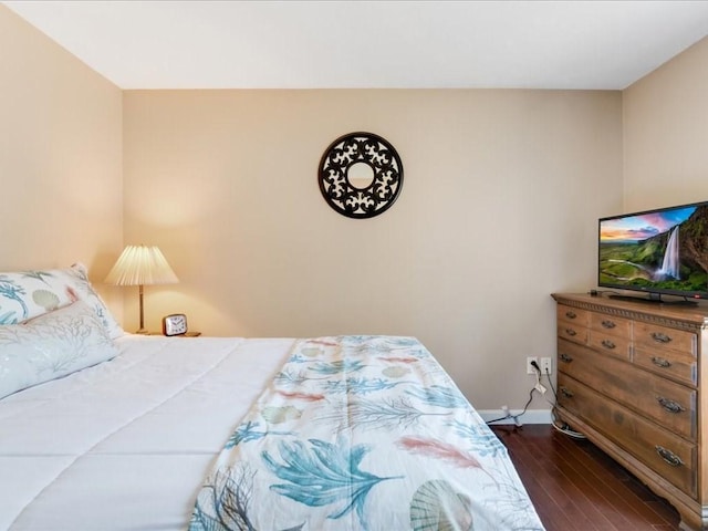 bedroom featuring baseboards and dark wood-style floors