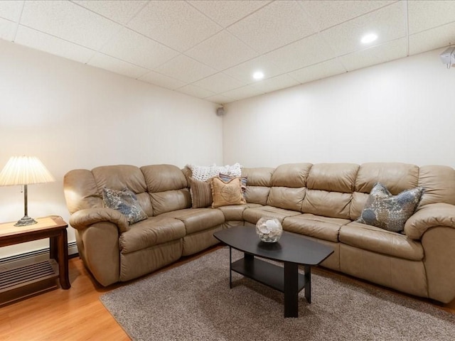 living area featuring recessed lighting, a drop ceiling, and light wood-style flooring