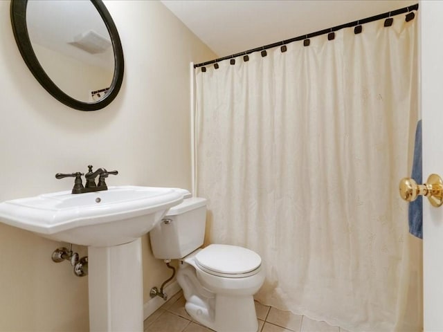 full bath with baseboards, toilet, and tile patterned flooring