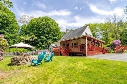 150 Appleton Cir, Fitchburg, MA 01420 - back of property featuring a gazebo, a chimney, a lawn, and stairs