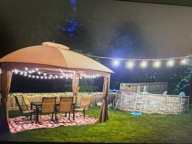 150 Appleton Cir, Fitchburg, MA 01420 - yard at night with a gazebo and a patio area