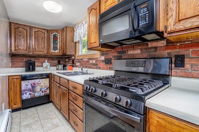 150 Appleton Cir, Fitchburg, MA 01420 - kitchen with black appliances, baseboard heating, a sink, and brown cabinets