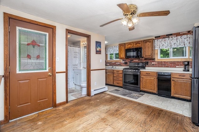 150 Appleton Cir, Fitchburg, MA 01420 - kitchen featuring appliances with stainless steel finishes, light countertops, light wood finished floors, and a ceiling fan