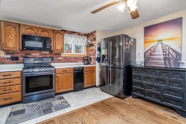 150 Appleton Cir, Fitchburg, MA 01420 - kitchen with black microwave, stainless steel gas range oven, refrigerator with ice dispenser, light countertops, and light wood-type flooring