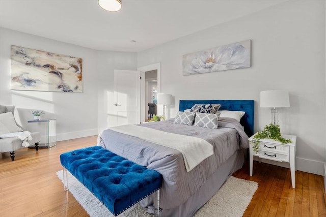 bedroom with baseboards and wood finished floors