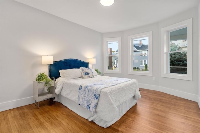 bedroom with baseboards and light wood-style floors