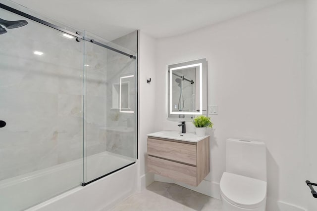 bathroom with vanity, toilet, and bath / shower combo with glass door