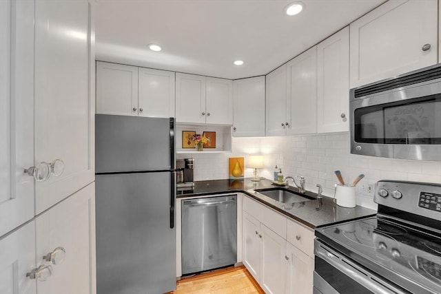 15 River Unit 306, Boston, MA 02108 - kitchen featuring appliances with stainless steel finishes, a sink, dark countertops, white cabinets, and recessed lighting