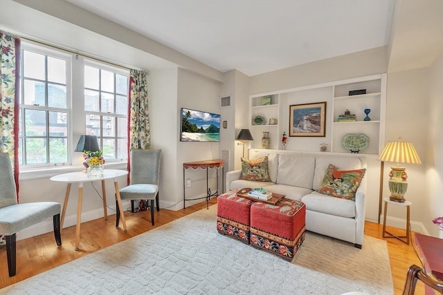 15 River Unit 306, Boston, MA 02108 - living room with plenty of natural light, wood finished floors, and baseboards