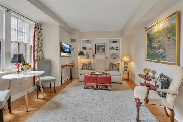 15 River Unit 306, Boston, MA 02108 - living area featuring wood finished floors, baseboards, and built in shelves