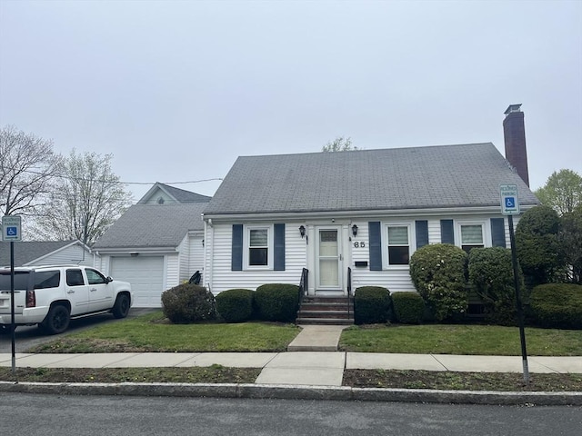 cape cod home with a chimney, a front yard, entry steps, and an attached garage