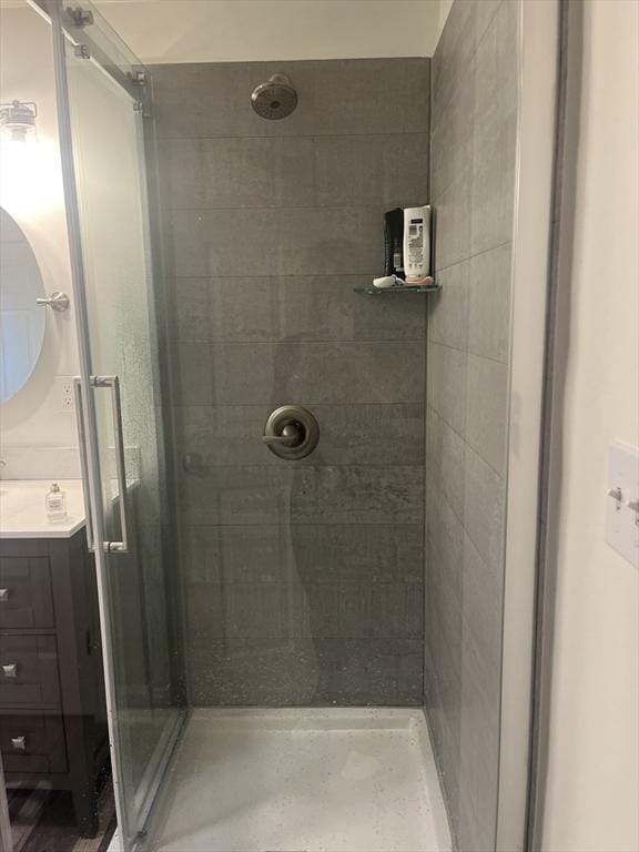 bathroom featuring a shower stall and vanity