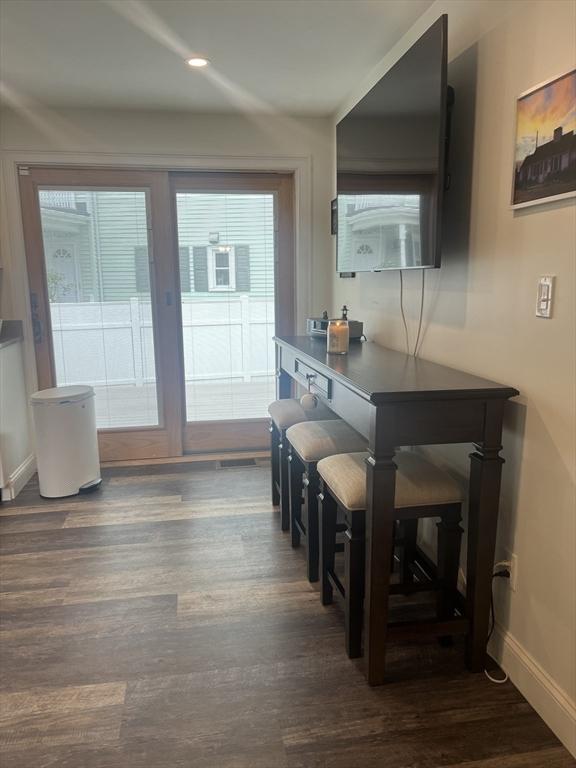 interior space featuring baseboards and dark wood finished floors