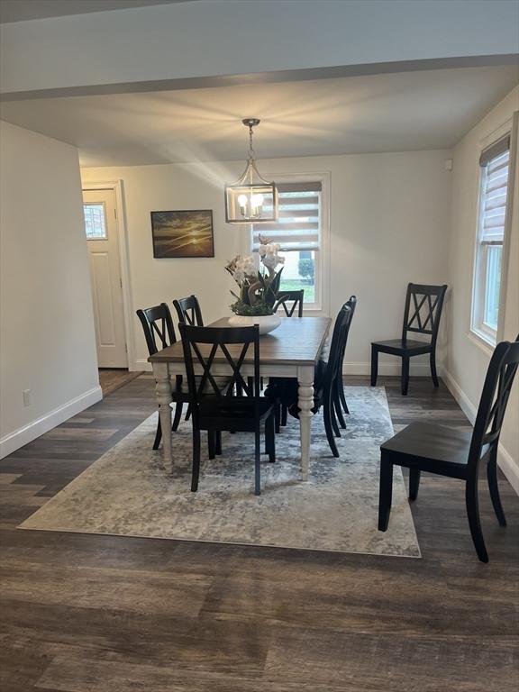 dining space with an inviting chandelier, a wealth of natural light, and baseboards