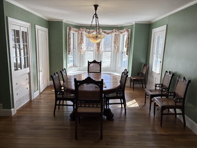 dining space featuring crown molding, baseboards, and dark wood-style flooring