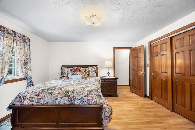 19 K St, Weymouth, MA 02189 - bedroom with light wood finished floors, baseboards, and a textured ceiling
