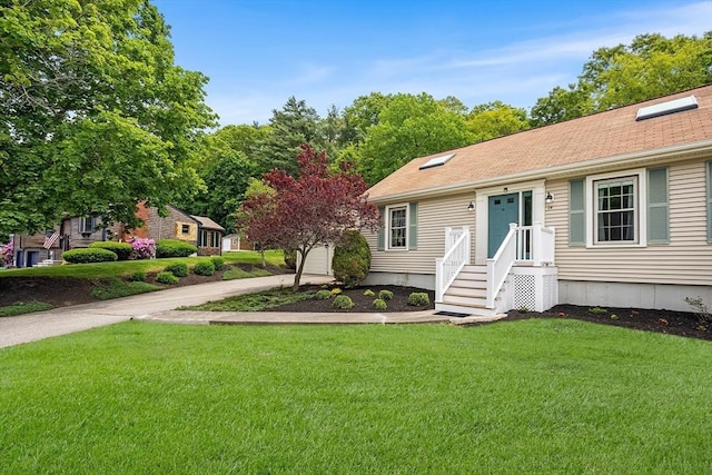 19 K St, Weymouth, MA 02189 - view of front of house featuring a front yard, concrete driveway, and a garage