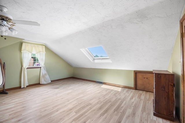 19 K St, Weymouth, MA 02189 - bonus room featuring a textured ceiling, a skylight, light wood-style floors, a ceiling fan, and vaulted ceiling