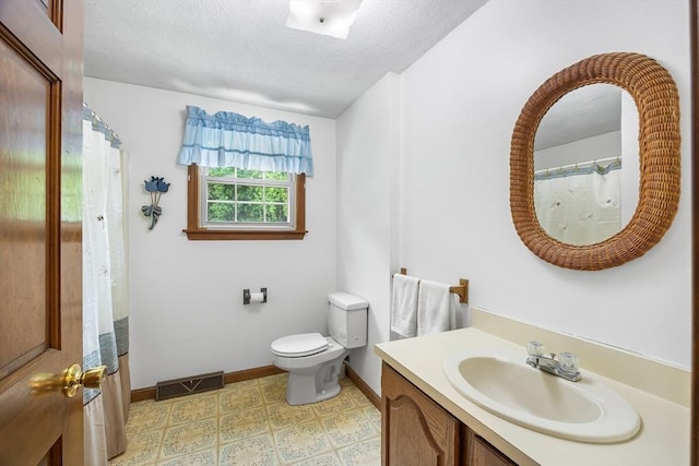 19 K St, Weymouth, MA 02189 - full bath with vanity, baseboards, toilet, tile patterned floors, and a textured ceiling