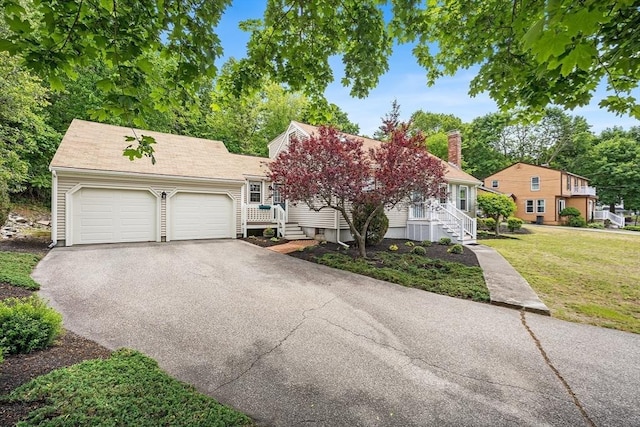 19 K St, Weymouth, MA 02189 - view of front of home with driveway, an attached garage, a front yard, and a chimney