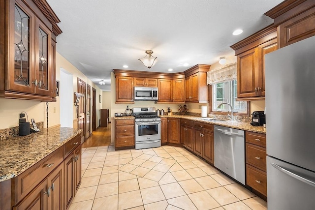 19 K St, Weymouth, MA 02189 - kitchen with stainless steel appliances, a sink, light tile patterned flooring, recessed lighting, and light stone counters