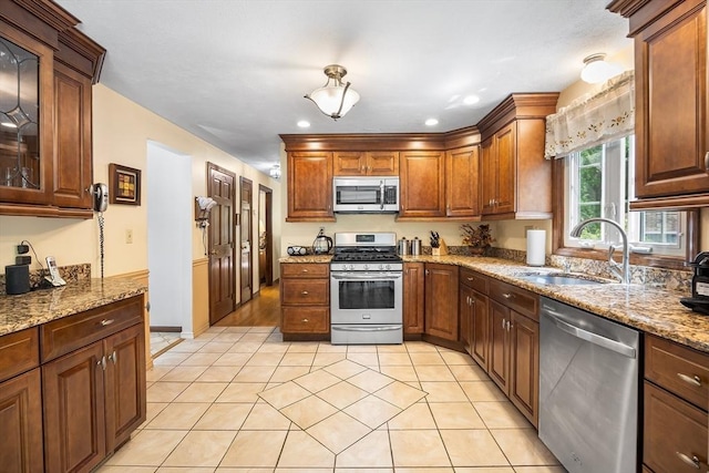19 K St, Weymouth, MA 02189 - kitchen with stainless steel appliances, a sink, light tile patterned floors, light stone countertops, and recessed lighting