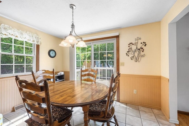 19 K St, Weymouth, MA 02189 - dining space with plenty of natural light, a wainscoted wall, and light tile patterned floors
