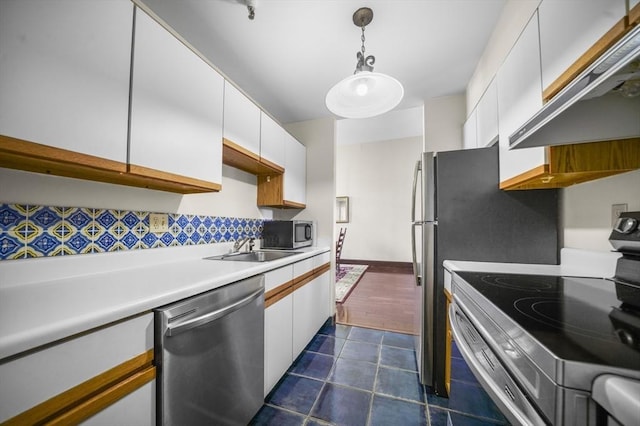 235 State St Unit 317, Springfield, MA 01103 - kitchen with appliances with stainless steel finishes, under cabinet range hood, white cabinetry, light countertops, and a sink