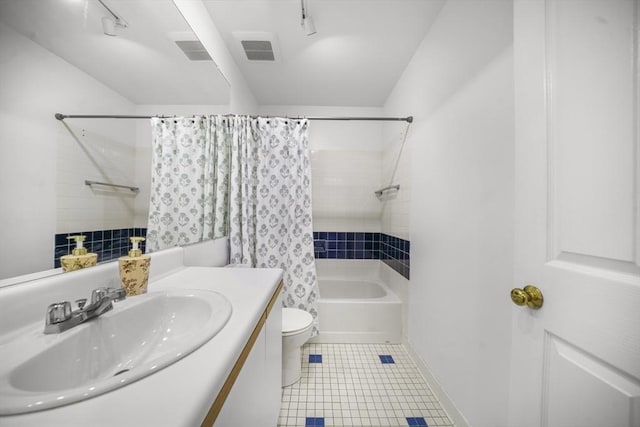 235 State St Unit 317, Springfield, MA 01103 - full bath featuring shower / bath combination with curtain, toilet, vanity, and tile patterned flooring