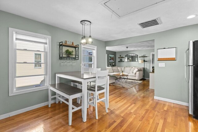 353 Medford St Unit 2, Malden, MA 02148 - dining room with attic access, light wood-style flooring, and baseboards