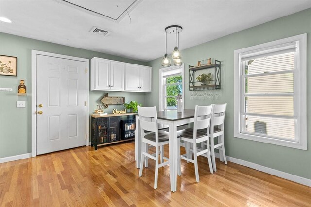 353 Medford St Unit 2, Malden, MA 02148 - dining area with attic access, light wood-type flooring, and baseboards