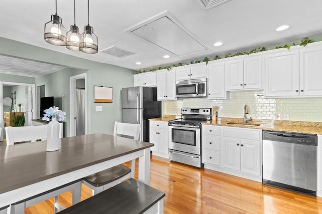 353 Medford St Unit 2, Malden, MA 02148 - kitchen with appliances with stainless steel finishes, a sink, white cabinetry, and recessed lighting